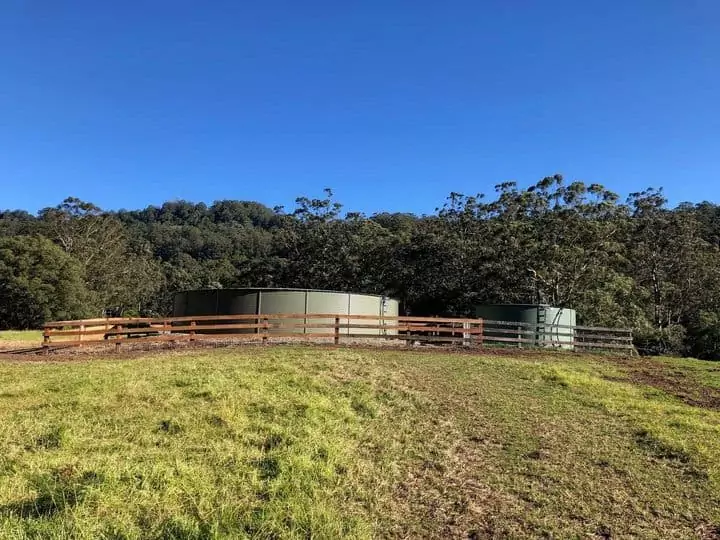Fenced in water tank for horses